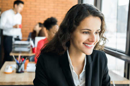 Attractive smiling businesswoman working in creative officeの写真素材