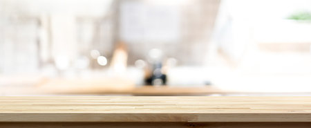 Wood countertop (or kitchen island) on blur kitchen interior background - can be used for display or montage your products (foods)の写真素材