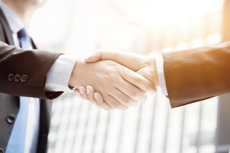 Businessmen making handshake - greeting, dealing, merger and acquisition conceptsの写真素材