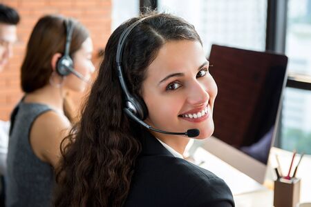Smiling beautiful businesswoman working in call centerの写真素材