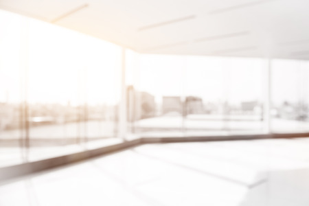 Blur empty white office room with glass wall, city building viewの写真素材