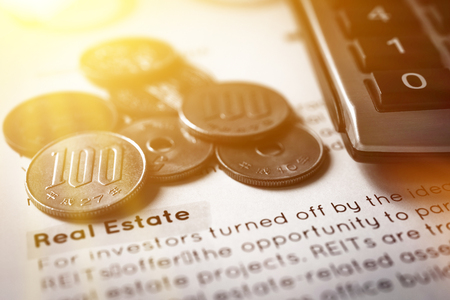 Money, Japanese yen coins, on real estate report sheet - investment conceptの写真素材