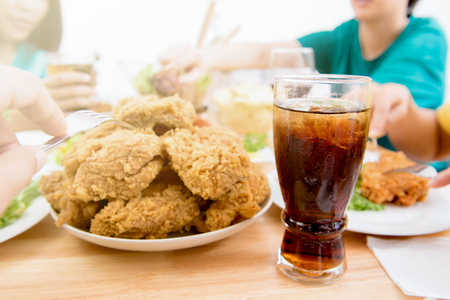 Fried chicken and soft drink on dining table in fast food restaurantの写真素材