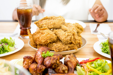Chicken, salad and drink on dinning table, ready to eatの写真素材