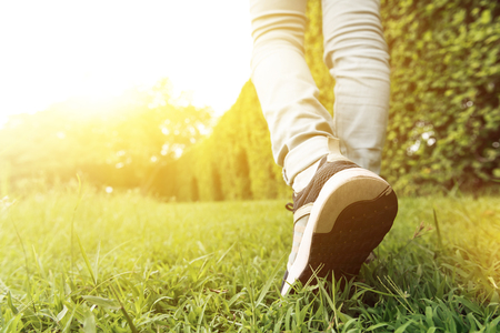 Woman walking in the garden, lower legs close upの写真素材