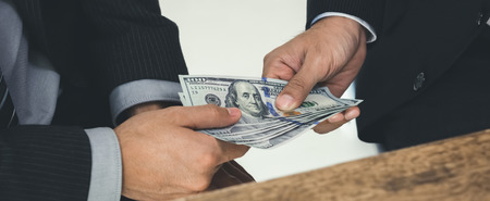 Businessmen secretly passing money, bribery and corruption concepts - panoramic bannerの写真素材