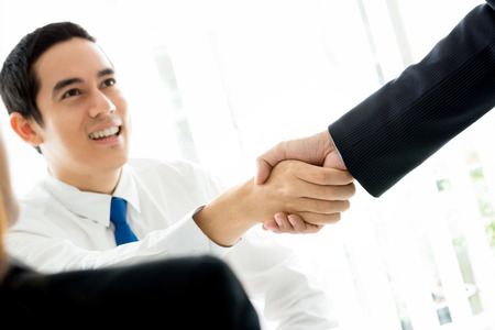 Businessmen making handshake in meeting room - greeting, dealing and congratulation conceptsの写真素材