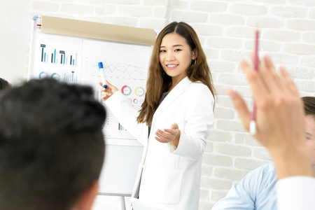Young Asian businesswoman making a presentation and asking for opinion in the meeting - female leader conceptの写真素材