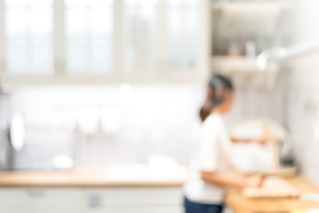 Blur modern kitchen interior with a person - for backgroundの写真素材