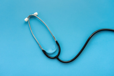Medical instrument stethoscope on light blue backgroundの写真素材