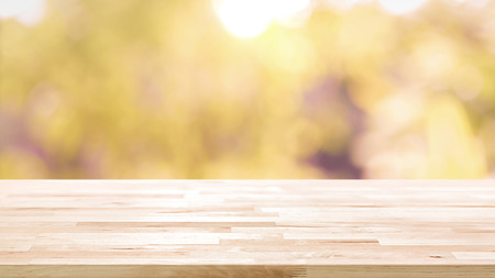 Wood table top on blur abstract natural foliage bokeh background, vintage tone - can be used for display or montage your productsの写真素材