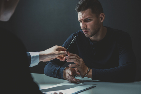 Criminal man in interrogation room refuse to admit crimeの写真素材