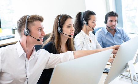 Group of business people telemarketing team working together in call center officeの写真素材