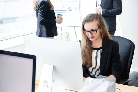 Businesswoman white collar worker concentrating on working with desktop computer in the officeの写真素材