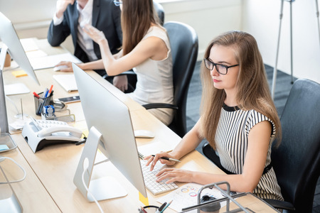 Businesswoman white collar worker concentrating on working with desktop computer in the officeの写真素材