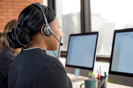 Black businesswoman working in call center as a telemarketing customer service agentの写真素材