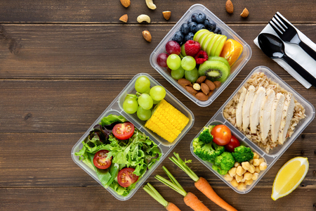 Clean healthy oil-free low fat ready to eat food in takeaway meal box sets on wood table background top viewの写真素材