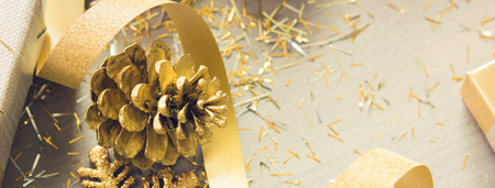 Curly ribbon with shimmer Christmas decorating items on wood banner background, silver and gold color themeの写真素材