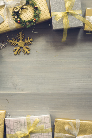 Shiny Silver and gold Christmas gift boxes on wood background top view border design with copy spaceの写真素材