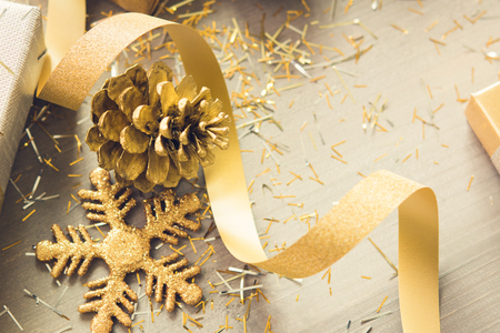 Curly ribbon with shimmer Christmas decorating items on wood background, silver and gold color themeの写真素材