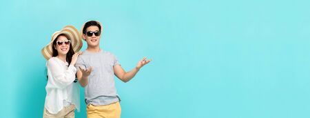 Happy Asian couple in summer beach casual clothes studio shot isolated on light blue banner background with copy spaceの写真素材