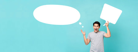 Excited young Asian man with thought bubbles studio shot isolated on light blue banner background