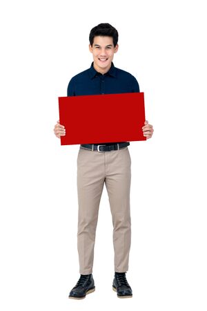 Young smiling handsome Asian man holding blank red board studio shot isolated on white backgroundの写真素材