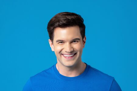 Young friendly smiling caucasian man in plain blue t-shirtの写真素材