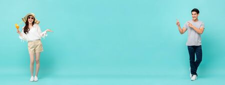 Young casual happy Asian man and woman on light blue long banner background with copy spaceの写真素材