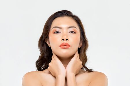 Beauty shot of glamorous Asian woman with makeup on her face isolated on white backgroundの写真素材