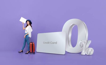 Smiling happy Asian tourist woman and credit card with 0% interest installment payment plan promotion against purple backgroundの写真素材