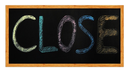 Closed word written with chalk on a blackboard の写真素材