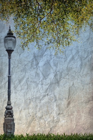 Lamp Street Road Light Pole and Green leave on old grunge paperの写真素材