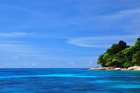Blue Sea with coral reef and fluffy clouds from tachai island in Thailandの写真素材