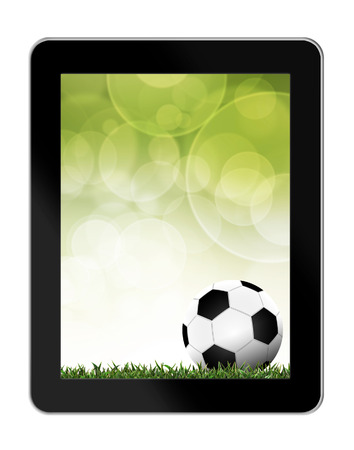 Football in green grass with background in tablet-pcの写真素材