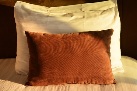 Comfortable soft pillows on the bedの写真素材