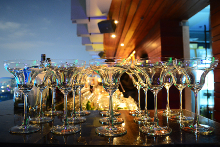 Empty glasses in row background at restaurant partyの写真素材