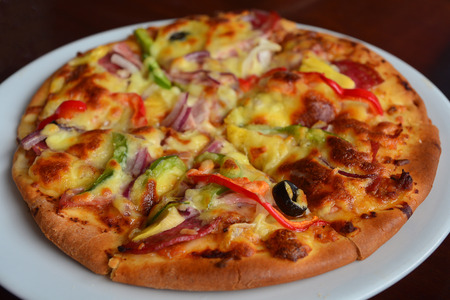 italian pizza with mozzarella, cheese and basil leavesの写真素材