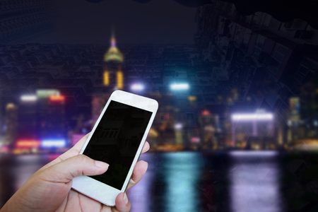 Closed up hand of man touch screen, Night view backgroundの写真素材