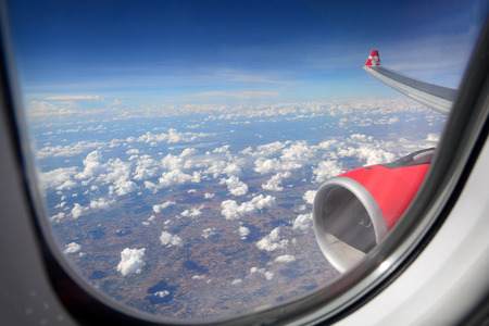 View from the window of an airplane flying in the cloudsの写真素材