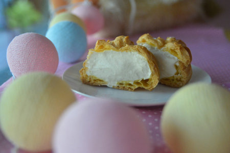 Cream puff cakes with custard on pastel background , Choux cream