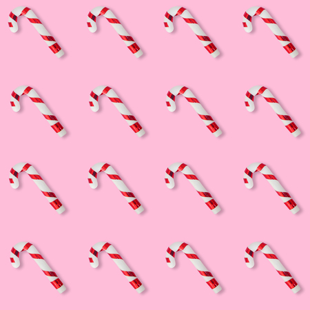Christmas candies cane pattern on pink background, for New Year and Christmas background.の写真素材