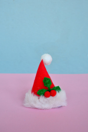 Santas hat on pink and blue background with copy space, Christmas and New year Conceptの写真素材