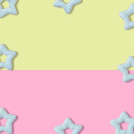 Christmas pastel yellow and pink background with glitter star, New Year greeting card, minimal conceptの写真素材