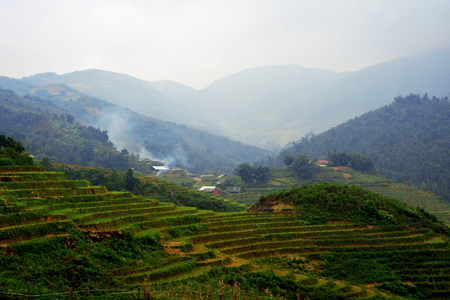 Beautiful landscape with green field on mountains and cloudy sky in Sa Pa, Vietnamの写真素材