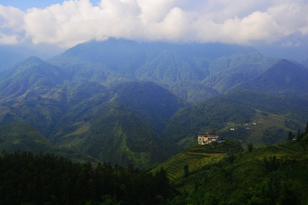 Beautiful landscape with green field on mountains and cloudy sky in Sa Pa, Vietnamの写真素材