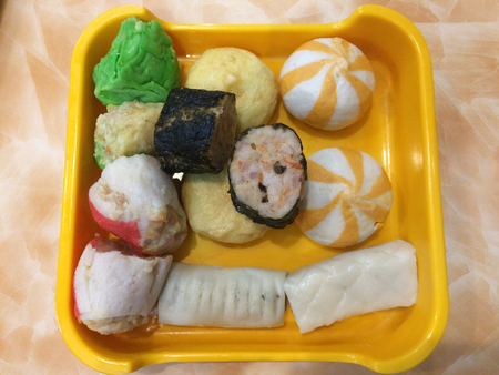 Mixed fish dumplings, fish ball on dish with sauceの写真素材