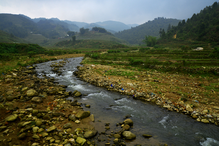 Beautiful landscape with green field on mountains and cloudy sky in Sa Pa, Vietnamの写真素材