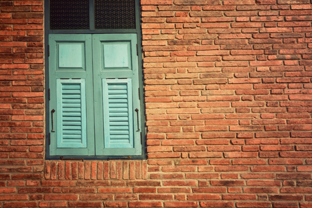 Old brick Wall with blue Window,Vintage style backgroundの写真素材