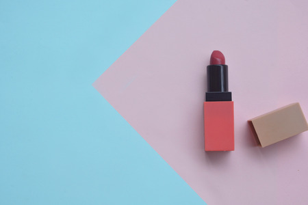 Red lipstick isolated on pastel background, Minimal makeup fashion concept. の写真素材